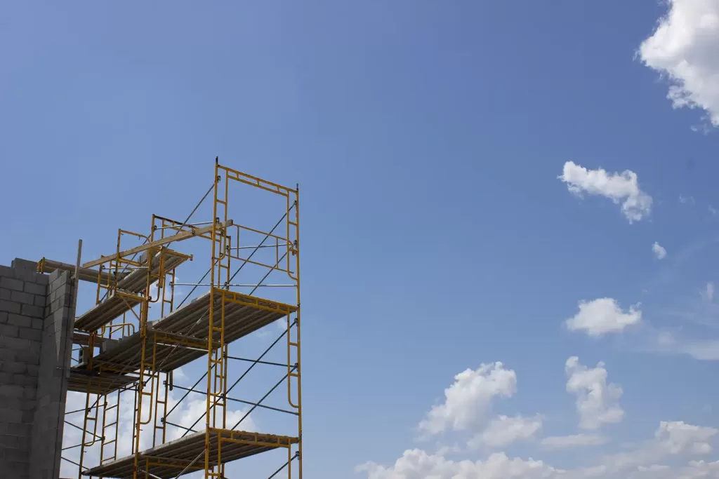 Scaffolding towers with walkboards high in the air.