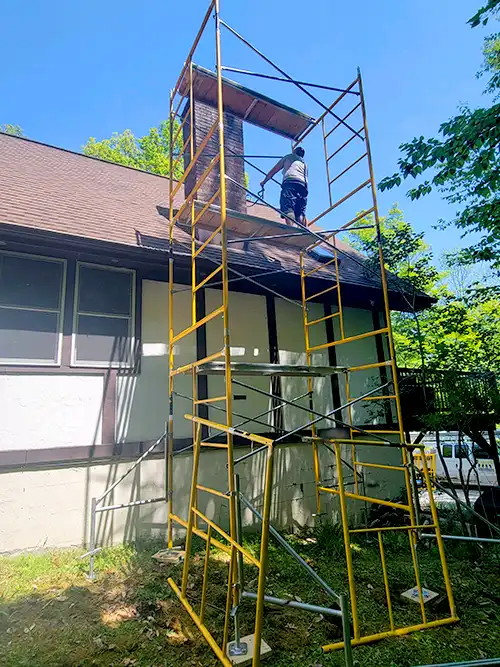 Scaffolding tower in use while working on house roofing