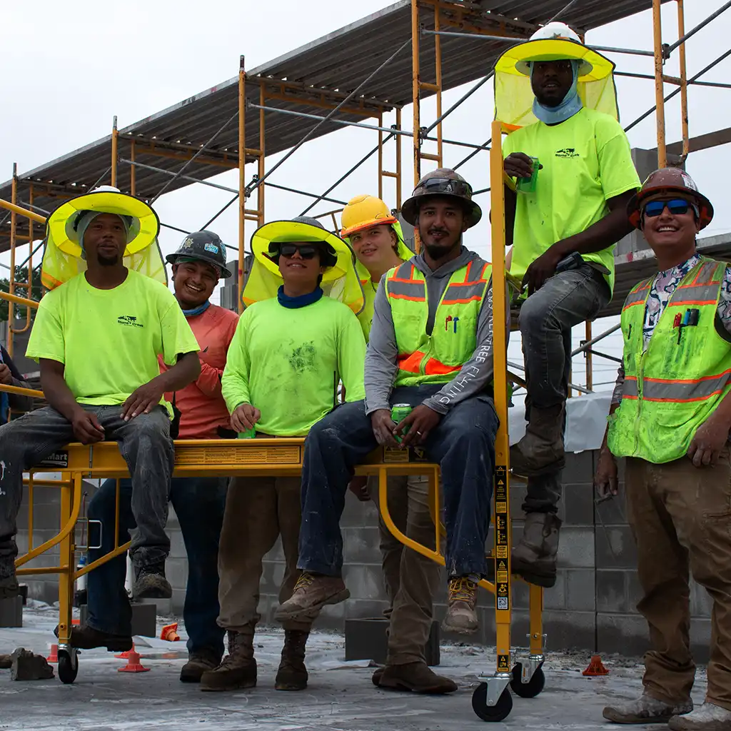 Masonry workers on bakers rack scaffolding.